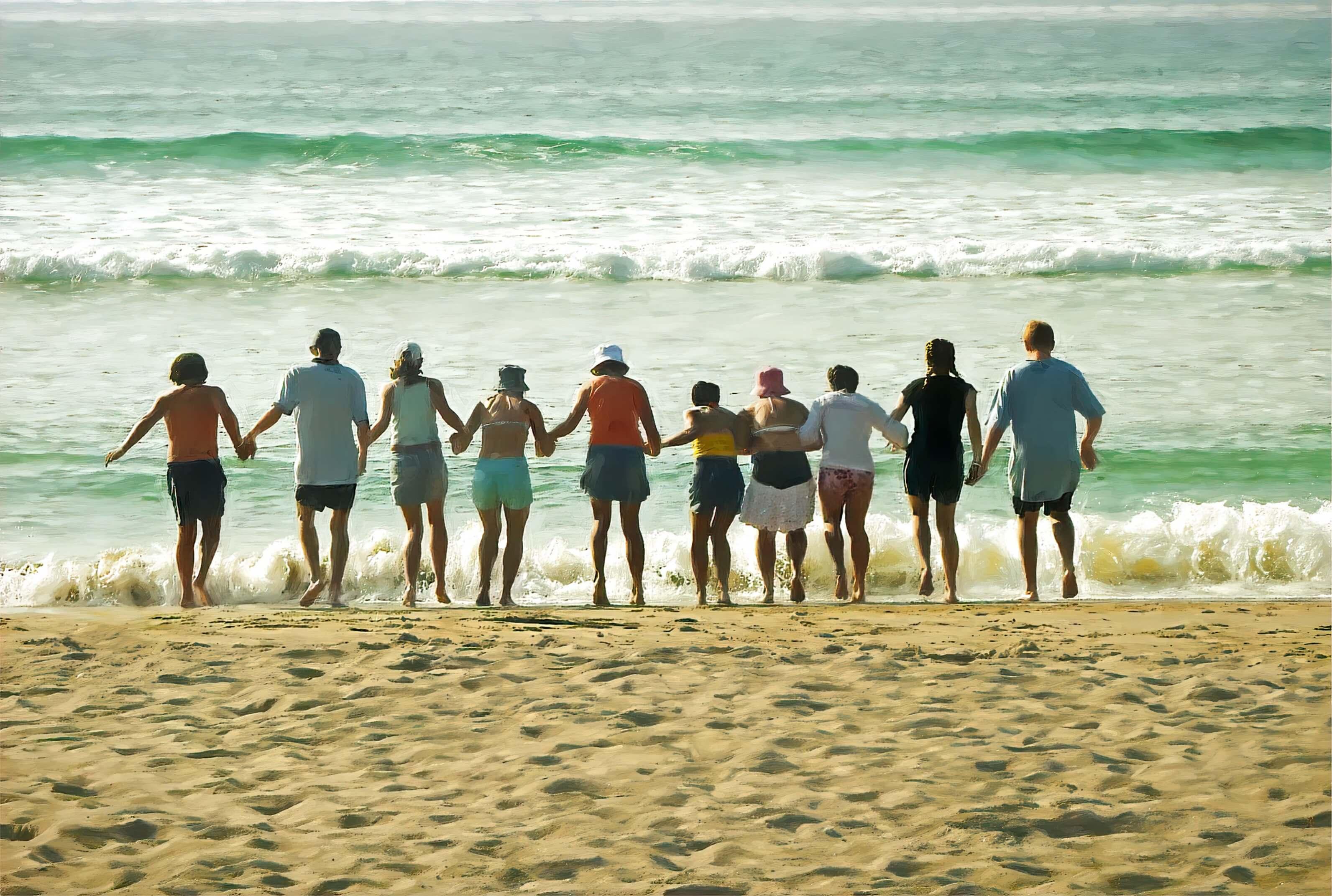 Ten people holding hands in a row in bright summer clothing, jumping the waves rolling in on an aquamarine sea.