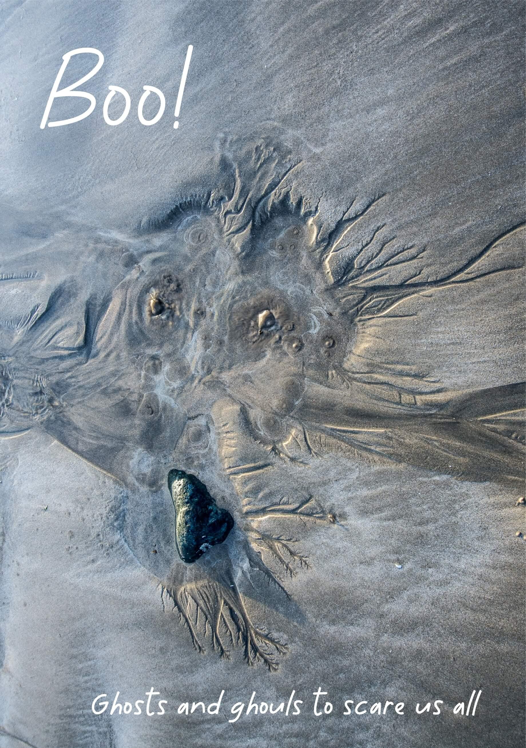 The imprint of a ghoulish face in the sand created by the tide retreating, sand bubbles up in watery cauldrons.